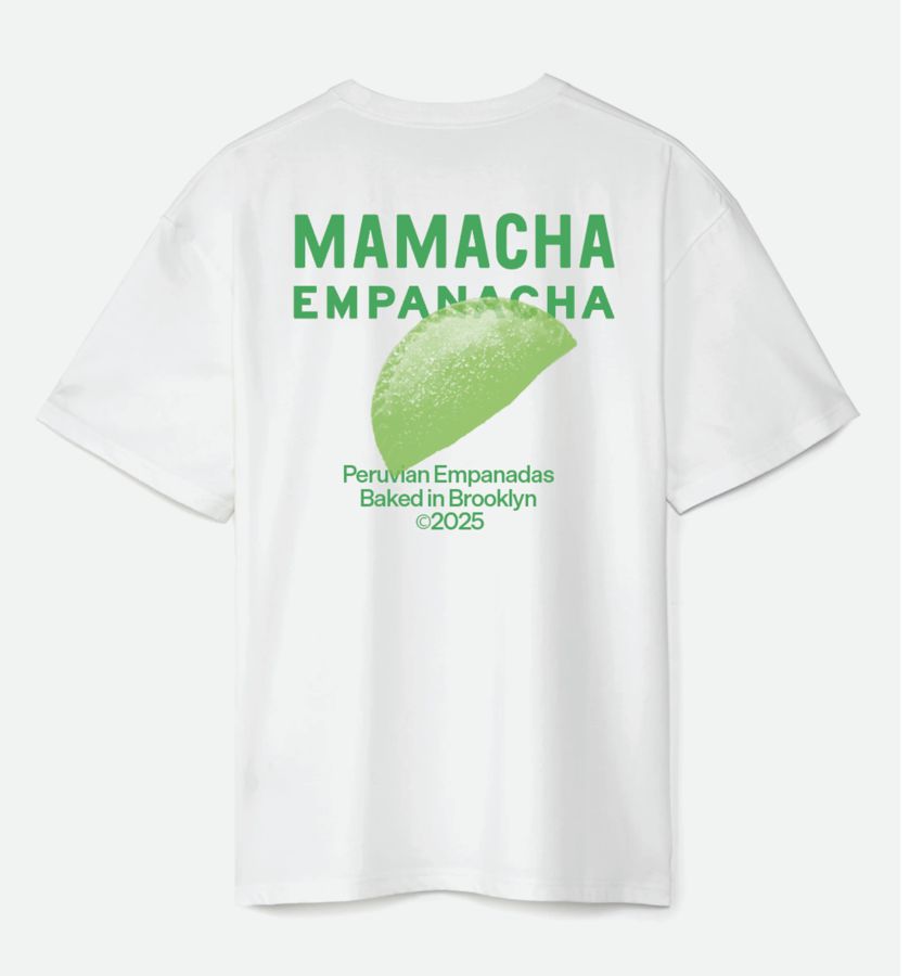 Back of the white tee with the large Mamacha Empanacha logo, a green empanada and the words Peruvian Empanadas Baked in Brooklyn